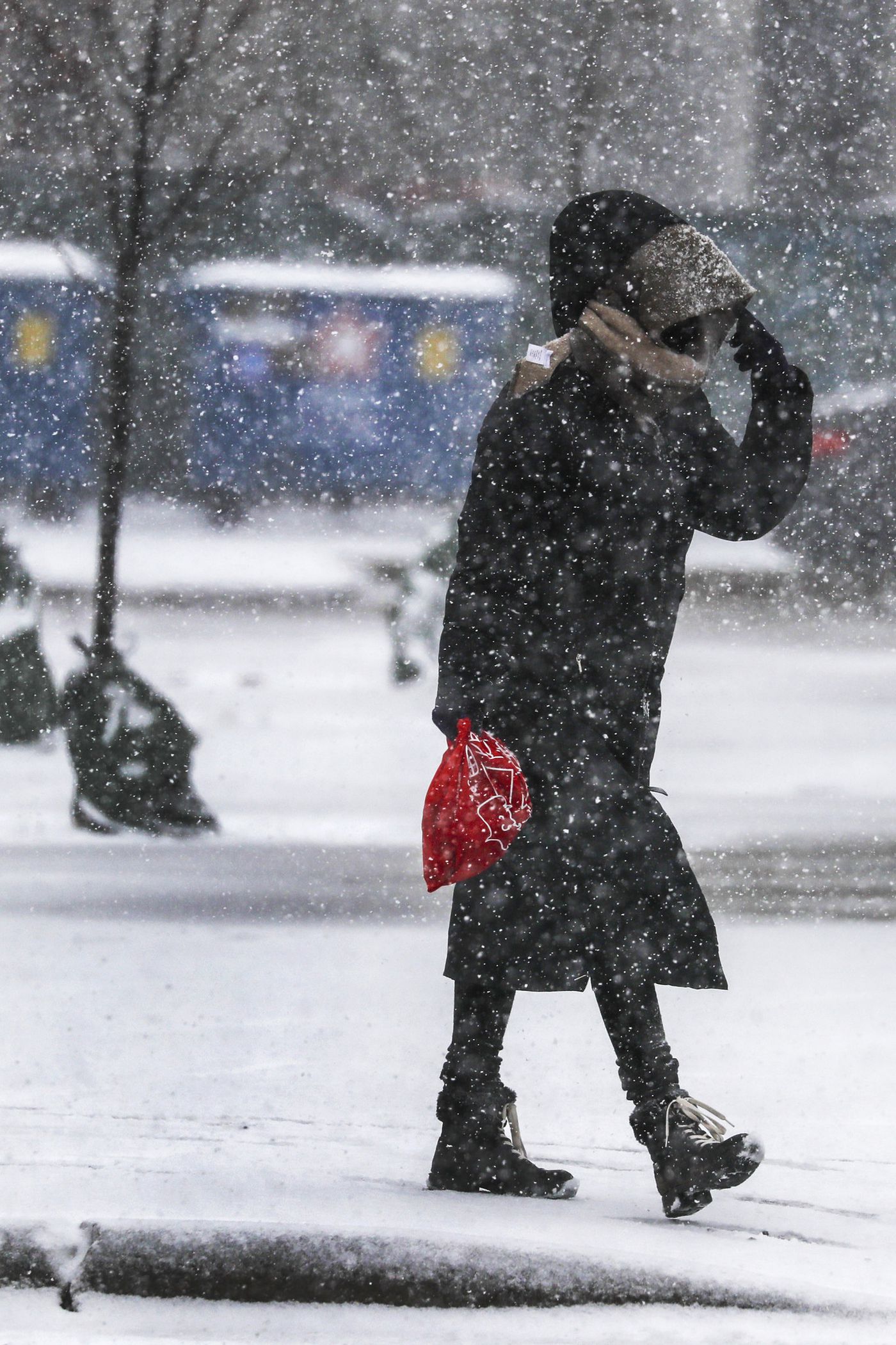 A woman walks on the 2600 North Milwaukee Avenue, March 15, 2021.