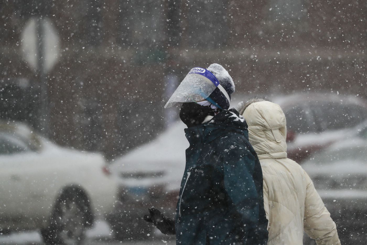 People brave snowy North Milwaukee Avenue in Chicago's Logan Square neighborhood, March 15, 2021.