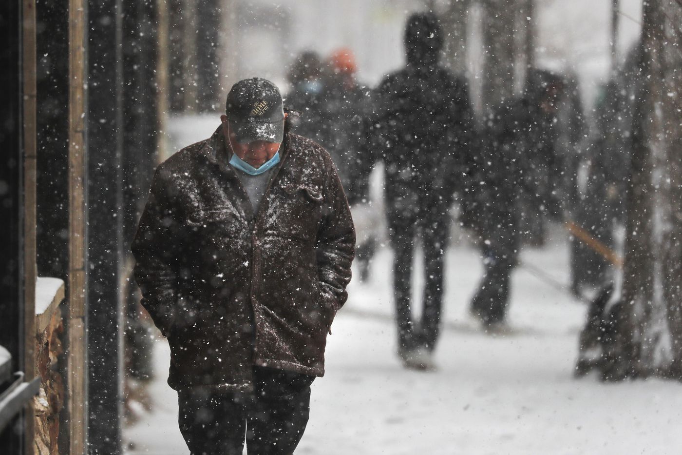 A man walks on the 2600 block of North Milwaukee Avenue in Chicago's Logan Square neighborhood on March 15, 2021.