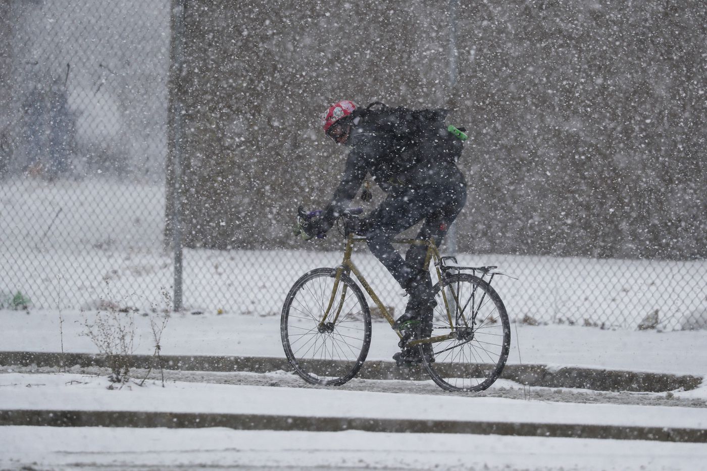 A man rides his bike on West Logan Boulevard approaching North Milwaukee Avenue in Chicago's Logan Square neighborhood on March 15, 2021.