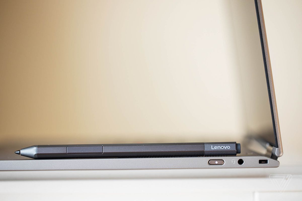 The Lenovo ThinkPad X1 Titanium Yoga from the left side with the stylus on top of the keyboard.