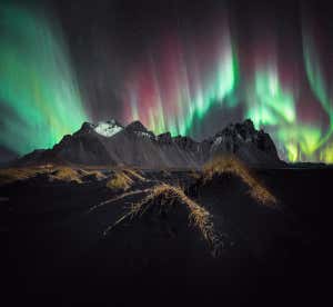 Spectrum ? Stefan Liebermann The Northern Lights over the famous Icelandic mountain, Vestrahorn. A panorama of three photos, processed with Lightroom and Photoshop. Taken with Sony ILCE-7SM3 camera, 14 mm f/1.8, 2-second exposure Location: Vestrahorn, Iceland