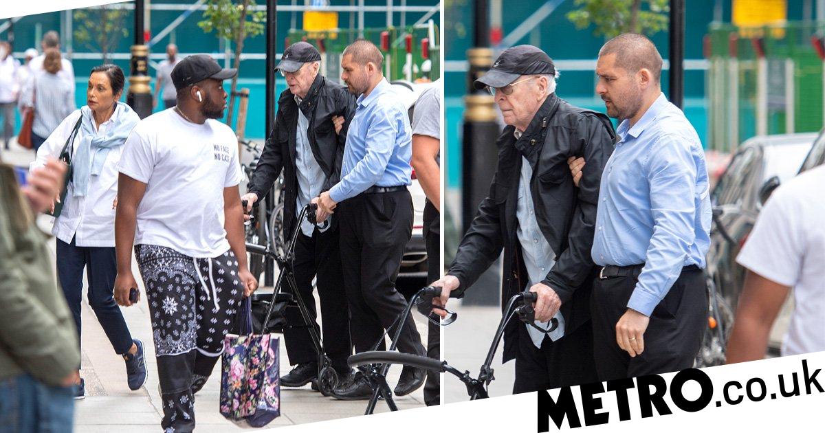 Sir Michael Caine, 89, uses walking frame on day out in London with wife Shakira